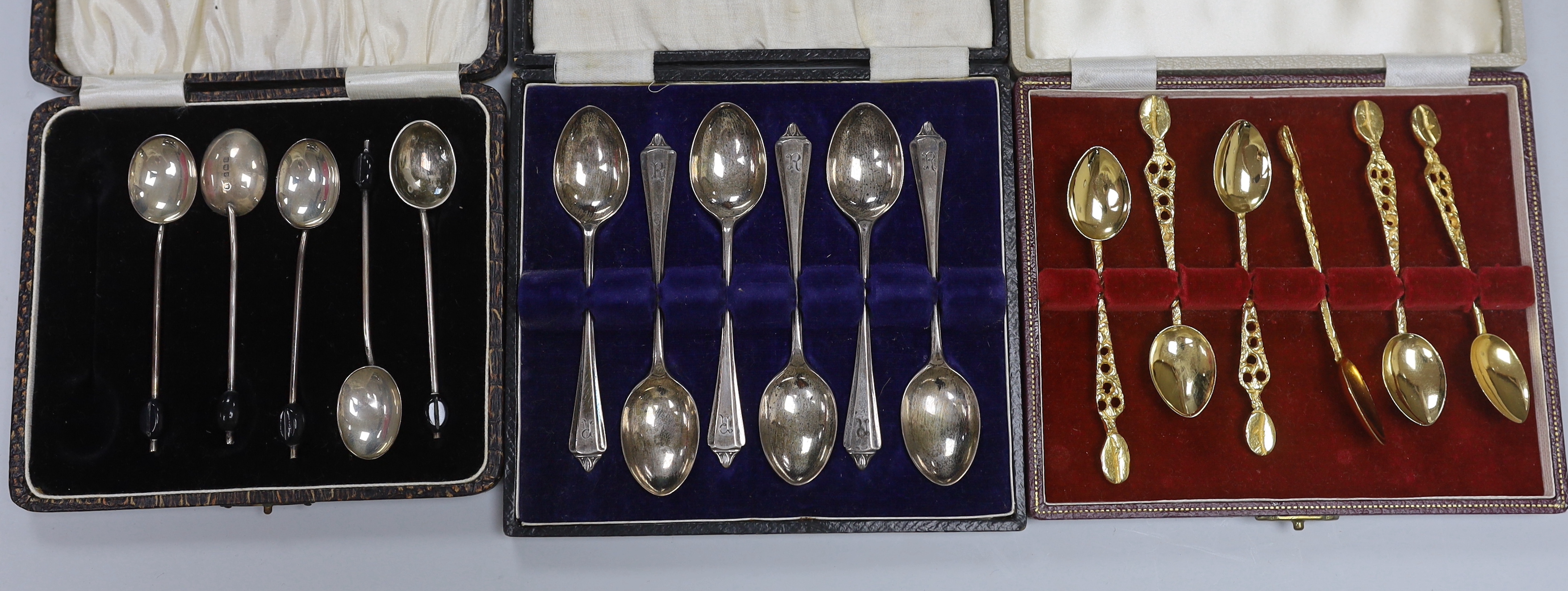 Assorted silver and white metal items including capstan inkwell, mug, photograph frame, cased and loose flatware, anointing spoon replica, beakers etc.